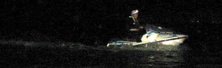 A lighted escort guides Chris and the sailboat back to the marina